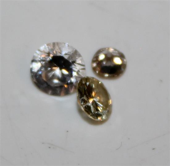 Two unmounted diamonds and one other colourless stone.